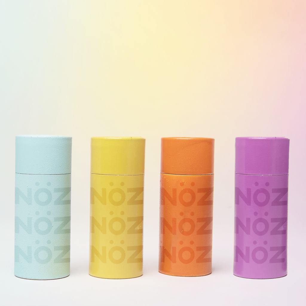 Various colours of NOZ Earth friendly sunscreen aligned in a row