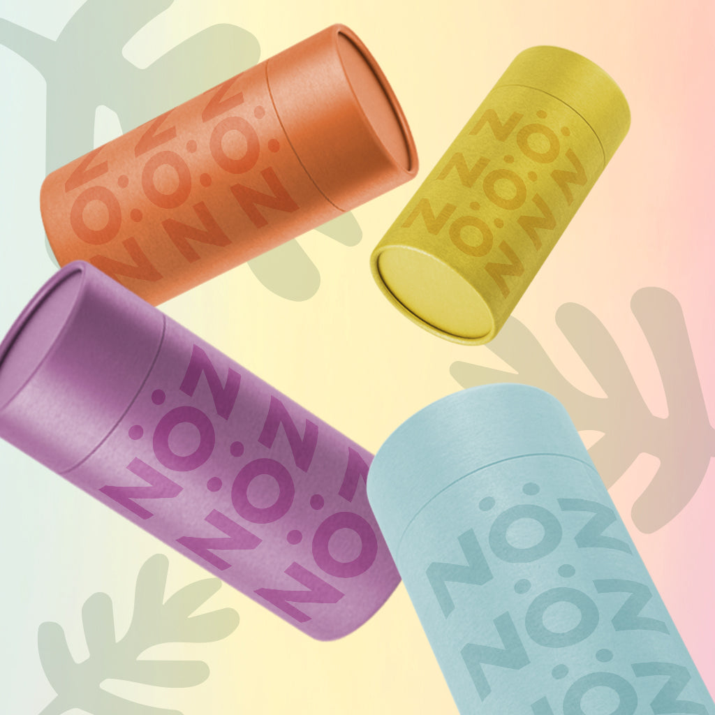 NOZ colorful sunscreen in all colours arranged on a playful gradient background